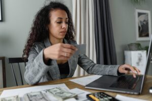 A woman organizing her finances after getting her divorce and mortgage questions answered.