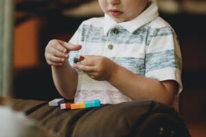 A young child playing with small blocks. Learn how consulting an attorney experienced with DCF In Massachusetts Divorce cases can protect young children now and in the future.
