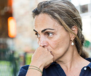 A woman with a contemplative look on her face - learn the 8 reasons why women divorce.