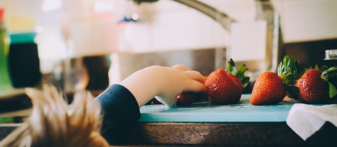 Accepting Help during or after a divorce can help you regain your balance and, like this little girl reaching for strawberries, get your hands around your new life
