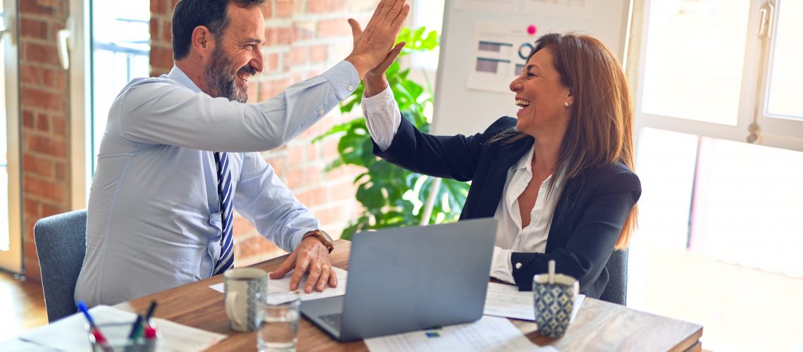 A couple exchanging a high five to celebrate finalizing a divorce team of support