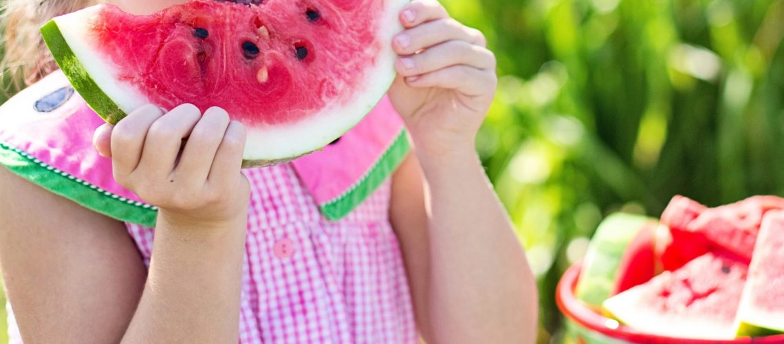 This little girl enthusiastically enjoying watermelon could easily be one of our ideas for single moms inexpensive activities shared in today's post.